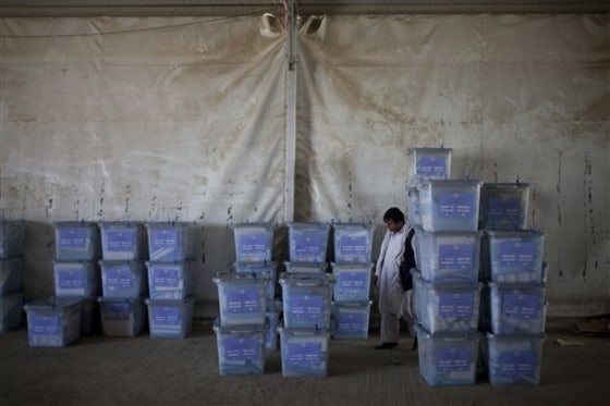 An Afghan election worker checks ballot boxes at Afghanistan's Independent Election Commission in Kabul on Sunday. Afghan election observers said they had serious concerns about the legitimacy of Saturday's parliamentary balloting as officials began Sunday to tally the results, a process that could take months.